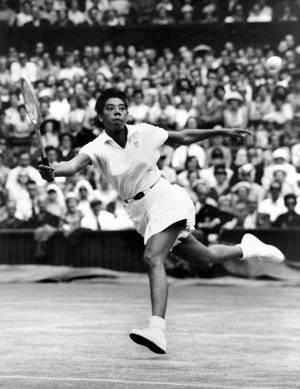 Iconic Althea Gibson Swinging Tennis Racket Wallpaper