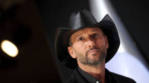 Iconic Country Star Tim Mcgraw Illuminated By Spotlights Wallpaper