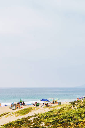 Iconic Malibu Beach With People Wallpaper