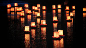 Illuminate Tranquility - Serene Array Of Floating Candles Wallpaper