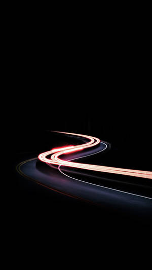 Illuminated Black Iphone Displaying Time-lapse Of Moving Car Wallpaper