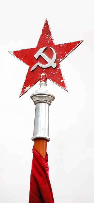 Illuminated Red Star On Tower Signage At Night Wallpaper