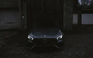 Image A Sleek And Sophisticated Black Mercedes Car Shining In The Sun Wallpaper