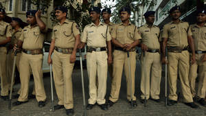 Indian Police Resting With Batons Wallpaper