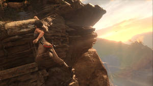 Intense Cliff Hanging Moment In Rise Of The Tomb Raider. Wallpaper