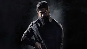 Intense Rocky Bhai Holding Rifle In Kgf Chapter 2 Wallpaper