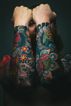 Intricate And Colorful Hd Tattoo Design On Arms Wallpaper