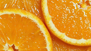 Invigorating Freshness: High-quality Image Of A Juicy Orange Fruit Wallpaper