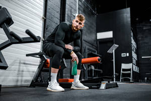 Invisible Chair In Black Fitness Gym Wallpaper