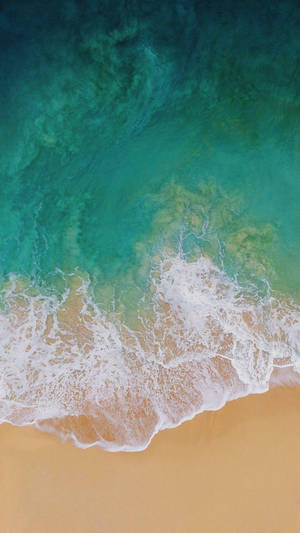 Ipad Pro Aerial View Of Waves On Shore Wallpaper