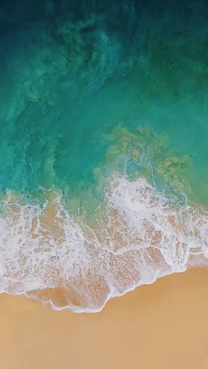 Ipad Pro Aerial View Of Waves On Shore Wallpaper