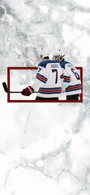 Jack And Quinn Hughes In Action - Sibling Rivals Of Ice Hockey Wallpaper