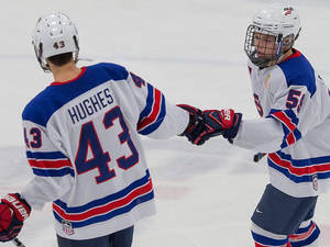 Jack Hughes Jubilantly Celebrates With His Teammates. Wallpaper