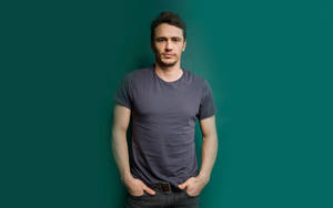 James Franco In Grey Shirt Against A Vibrant Green Background Wallpaper