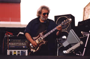 Jerry Garcia Playing Guitar Onstage Wallpaper