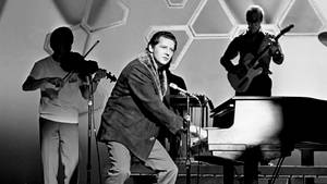 Jerry Lee Lewis Standing Near Piano Wallpaper