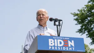 Joe Biden Giving Speech On Stage Wallpaper