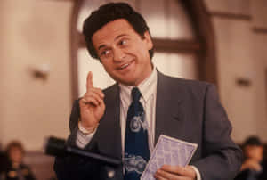 Joe Pesci Smiling With Finger Raised Wallpaper