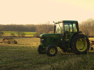John Deere Tractor In Sunset Field Wallpaper