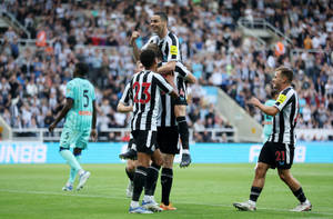 Jubilant Newcastle United Fc Players Celebrating A Victory Wallpaper