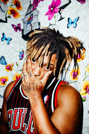 Juice Wrld Surrounded By His Artwork Wallpaper