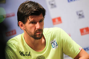 Jurgen Melzer Wearing Yellow At Conference Wallpaper