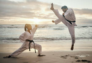 Karate Fight At Beach During Sunset Wallpaper