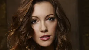 Katie Cassidy Striking A Pose In An Elegant Outfit Wallpaper