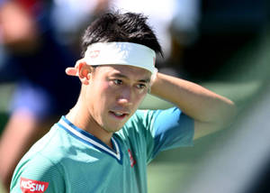 Kei Nishikori Pondering Strategy On The Tennis Court Wallpaper