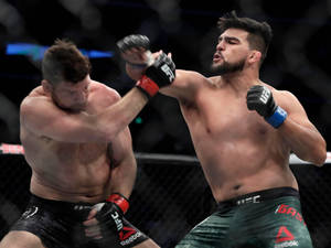 Kelvin Gastelum In Action In Mma Fight Wallpaper