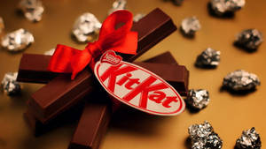 Kit Kat With A Red Ribbon Wallpaper