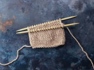 Knitting A Cream Yarn Wallpaper