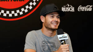 Kyle Larson Holding Microphone Wallpaper