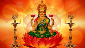 Lakshmi Devi Seated Between Two Lamps Wallpaper