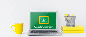 Laptop On Desk With Google Classroom Wallpaper