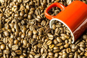 Large Red Mug Plunged Into The Coffee Beans Wallpaper