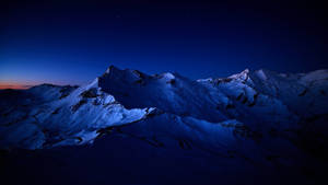 Lavender Lit View Of A Night Mountain Wallpaper