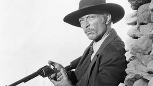 Lee Van Cleef Holding A Gun Photography Wallpaper