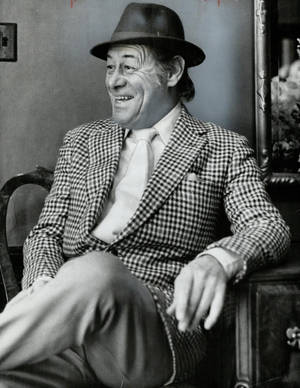 Legendary Actor Rex Harrison Radiates Joy And Laughter Wallpaper