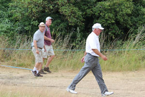 Legendary Golfer Mark O'meara Navigating A Grassy Path Wallpaper