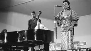 Legendary Jazz Artist Billie Holiday Performing On Stage Wallpaper
