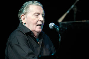 Legendary Music Icon, Jerry Lee Lewis Performing On Stage Wallpaper