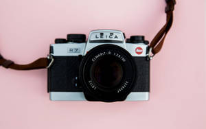 Leica Dslr Camera On Pink Wallpaper