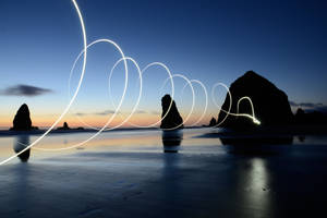 Light Painting On The Beach At Dusk Wallpaper