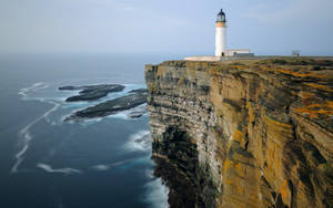 Lighthouse By Ocean Cliff Side Wallpaper