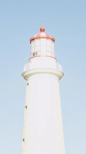 Lighthouse On A Baby Blue Sky Wallpaper