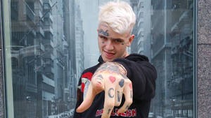 Lil Peep Gazing Off Into The Distance. Wallpaper