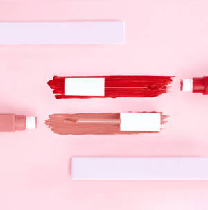Lipsticks On Pink Background Wallpaper