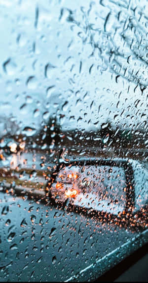 Listen To The Sound Of The Rain Amidst A Vibrant Cityscape Wallpaper