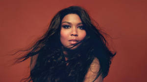 Lizzo In Red Brown Background Wallpaper